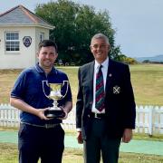 John Shanks is handed the Club Championship trophy for the eighth time by The Irvine Golf Club captain Stuart McInnes.