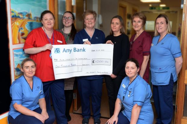 The ASU team, led by Charge Nurse Christine Somerville (third from left), receive the kind donation from Shaaron Boyle (third from right).