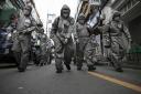 SEOUL, SOUTH KOREA - MARCH 04: South Korean soldiers, in protective gear, disinfect the Eunpyeong district against the coronavirus (COVID-19) on March 04, 2020 in Seoul, South Korea. The South Korean government has raised the coronavirus alert to the &quo