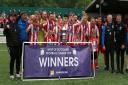Hurlford celebrate with their trophy. Credit: WoSFL