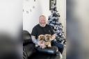Army veteran Bobby Jones in his new Irvine home, all decorated for Christmas, alongside his two Yorkshire terriers.