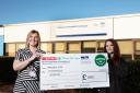 SPAR staff member Shannon Kenneth presents the cheque to Junior Doctor Yvonne Gormley