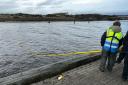 Coastwatch demonstrate the new rescue pole at the harbourside