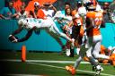 Miami Dolphins running back Raheem Mostert (31) scores a touchdown during the first half against the Denver Broncos (Rebecca Blackwell/AP)
