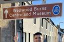 President of Irvine Burns Club Angus Middleton pictured with the new sign on Burns Street