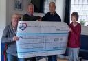 The Visually Impaired Group hand over the cheque