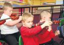 Pennyburn Primary pupils tried their hand at stringed instruments in 2014