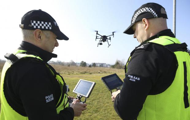 Irvine Times: Insp Nick Whyte, left, and Sgt Steven Pollock of the Police Scotland Air Support Unit control a drone at Jackton, East Kilbride. MISSING PERSONS feature STY..Pic Gordon Terris Herald & Times..23/3/22.