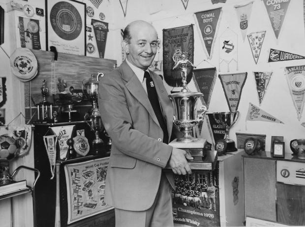 Irvine Times: Bobby Dinnie pictured at home in the 1970s with a collection of trophies.  Bobby Dinnie, now age 89, a retired football scout, was involved with the Possil YM football team for over 60 years and was responsible for discovering footballers Kenny Dalglish,