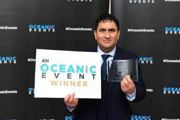 Madhav Bhandari of Motherland Spice shows off the award