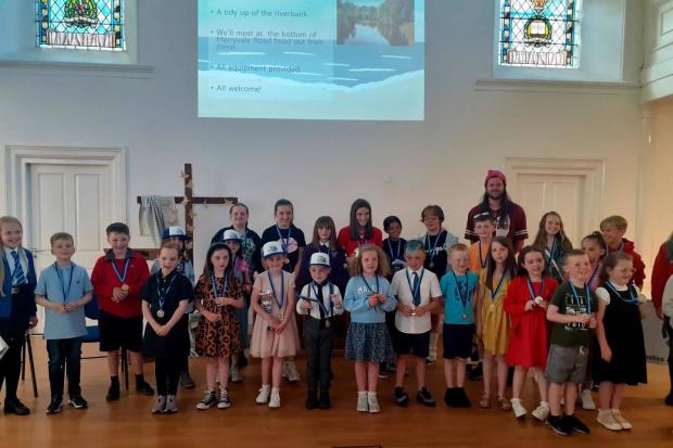 Pupils presented with environmental poster prizes by top artist Tragic O’Hara