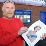 Graham Crawley with his tribute posters in memory of the Queen
