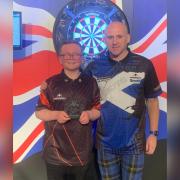 Kyle Davidson is handed his runner-up prize by Scottish darts star Alan Soutar who sponsored the JDC Scottish National Championship.