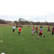 SHARPENING SKILLS: Greenwood Academy girls are pictured in action at the rugby festival.
